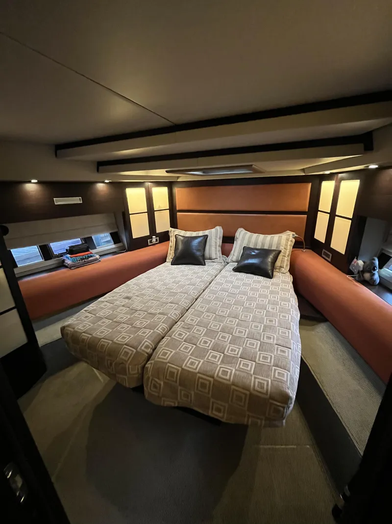 Slide: The Image of Luxurious bedroom interior of a 2008 Azimut 62S yacht with twin beds and modern decor. - 35