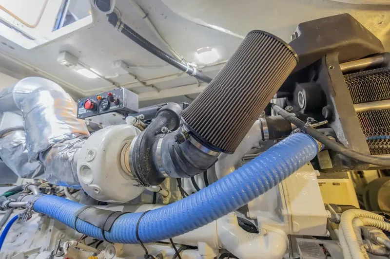 Slide: The Image of Engine room of a 2008 Azimut 62S yacht, featuring mechanical components and hoses. - 45