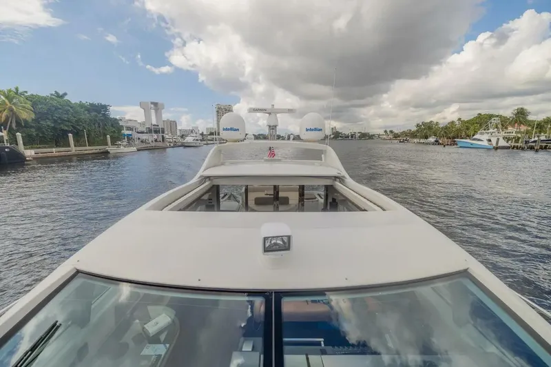 Slide: The Image of 2008 Azimut 62S yacht cruising on a scenic waterway under a partly cloudy sky. - 47
