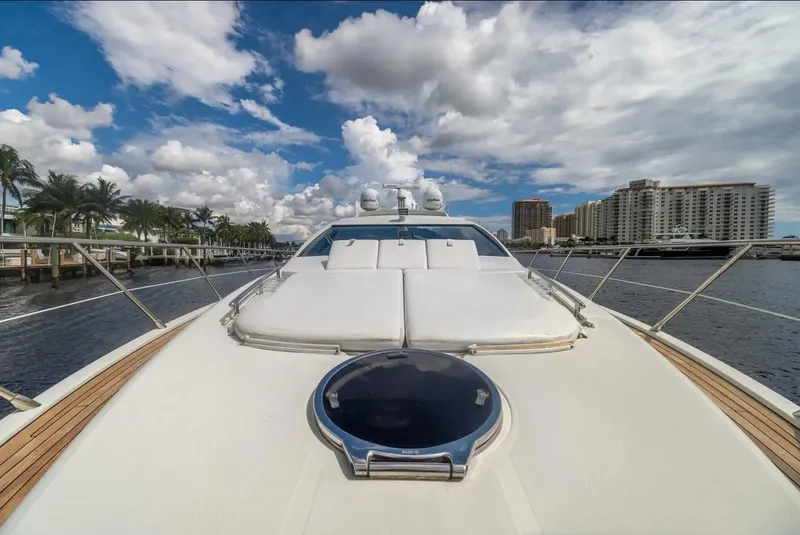 Slide: The Image of 2008 Azimut 62S yacht on water, clear sky, cityscape in background. - 48