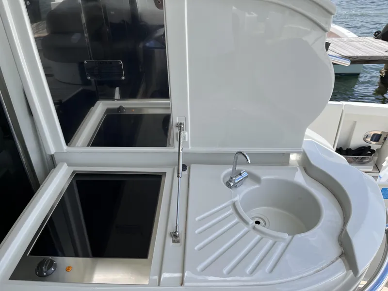 Slide: The Image of 2008 Azimut 62S yacht kitchenette with sink and stove, dockside view. - 49