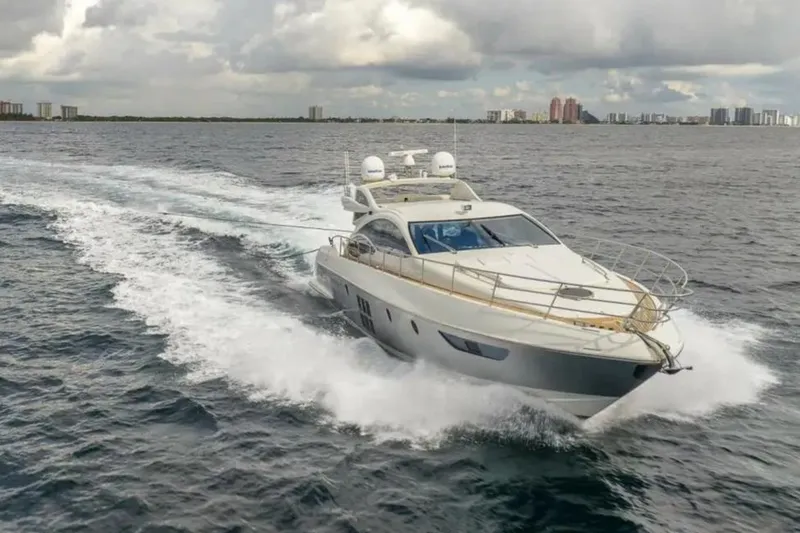 Slide: The Image of 2008 Azimut 62S yacht cruising on open water under cloudy skies. - 6