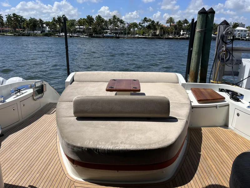 Slide: The Image of 2008 Azimut 62S yacht deck with sunbed, overlooking serene waterfront and palm trees. - 7