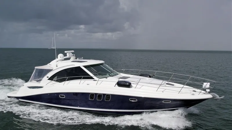 The Image of 2008 Sea Ray 480 Sundancer yacht cruising on open water under cloudy skies. - 0