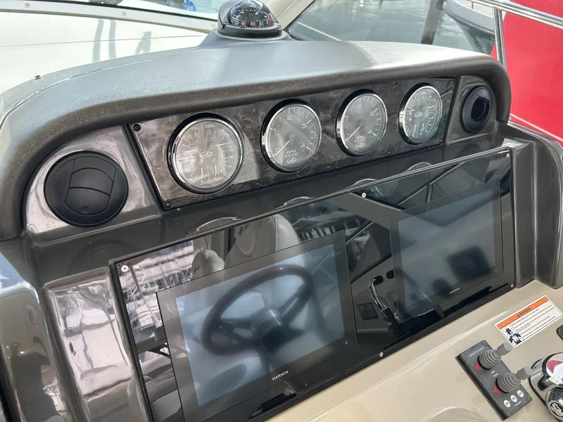 Slide: The Image of Helm of 2008 Sea Ray 480 Sundancer with gauges and navigation screens. - 15