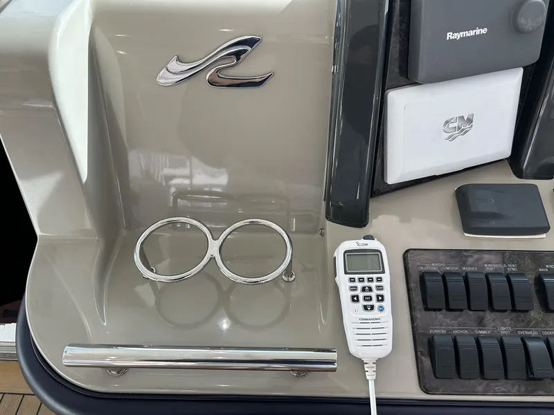 Slide: The Image of Control panel of 2008 Sea Ray 480 Sundancer with radio and cup holders. - 17