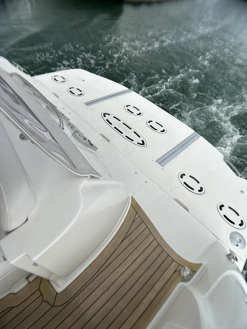 Slide: The Image of 2008 Sea Ray 480 Sundancer yacht deck with teak flooring on water. - 26