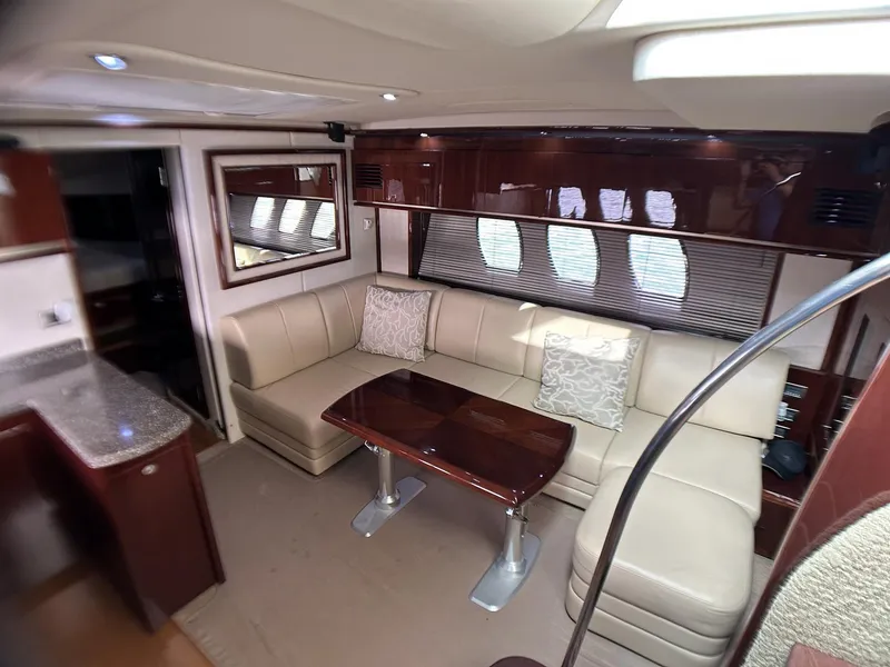 Slide: The Image of Luxurious interior of 2008 Sea Ray 480 Sundancer yacht with elegant seating and wooden table. - 29