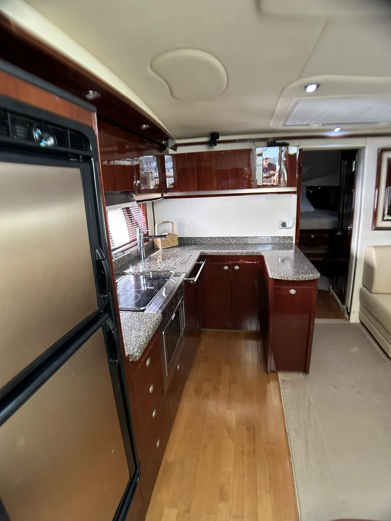 Slide: The Image of Luxurious kitchen interior of 2008 Sea Ray 480 Sundancer yacht with modern amenities. - 31