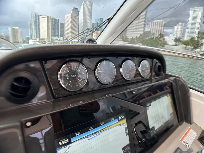 Slide: The Image of Dashboard of a 2008 Sea Ray 480 Sundancer yacht with city skyline in background. - 37