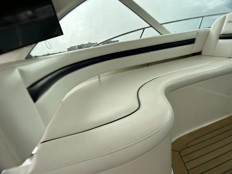 Slide: The Image of 2008 Sea Ray 480 Sundancer interior with white leather seating and sleek design. - 42