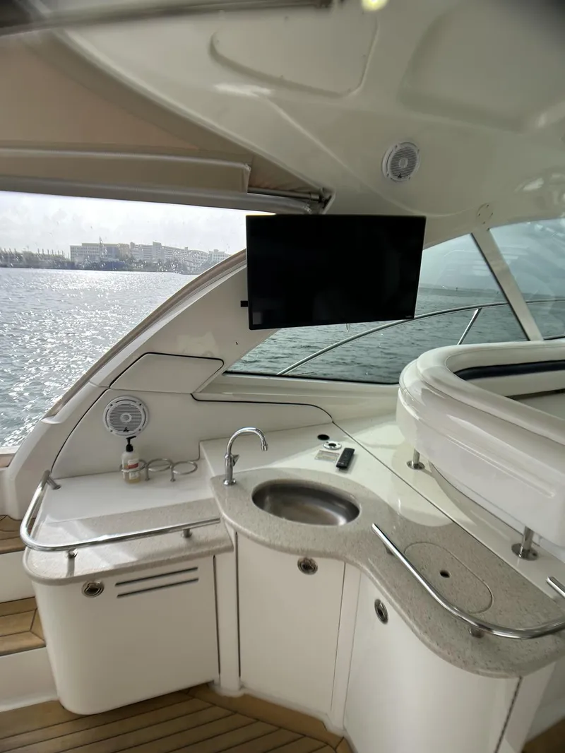 Slide: The Image of 2008 Sea Ray 480 Sundancer yacht interior with kitchenette and ocean view. - 43