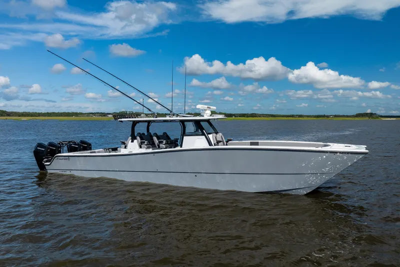 The Image of 2023 Freeman 47 boat on calm water under a clear blue sky. - 0
