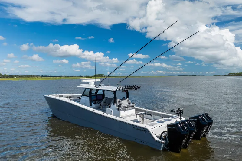 Slide: The Image of 2023 Freeman 47 boat on water with clear blue sky and clouds. - 10