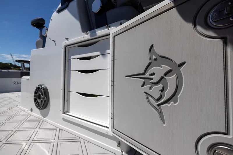Slide: The Image of 2023 Freeman 47 boat interior with marlin logo and storage drawers. - 104