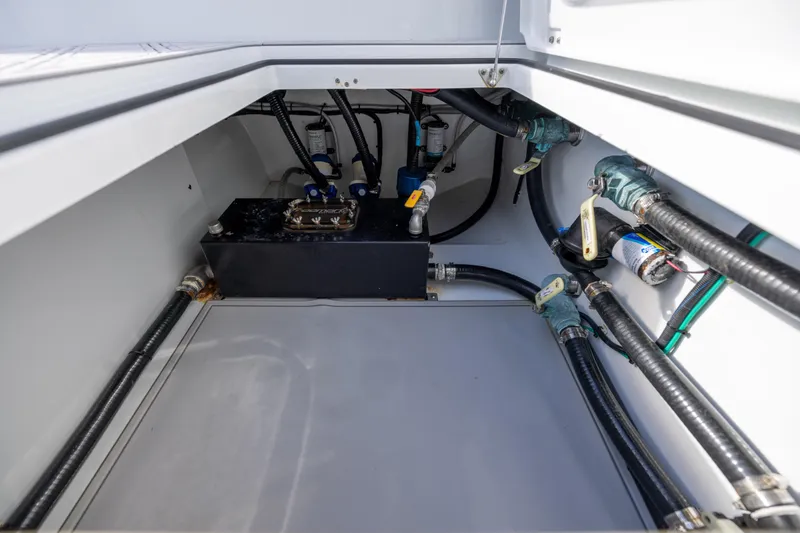 Slide: The Image of 2023 Freeman 47 boat compartment with hoses and mechanical components. - 109