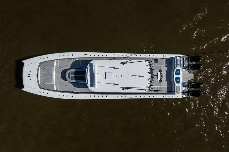 Slide: The Image of Aerial view of 2023 Freeman 47 boat on water, showcasing sleek design and powerful engines. - 17