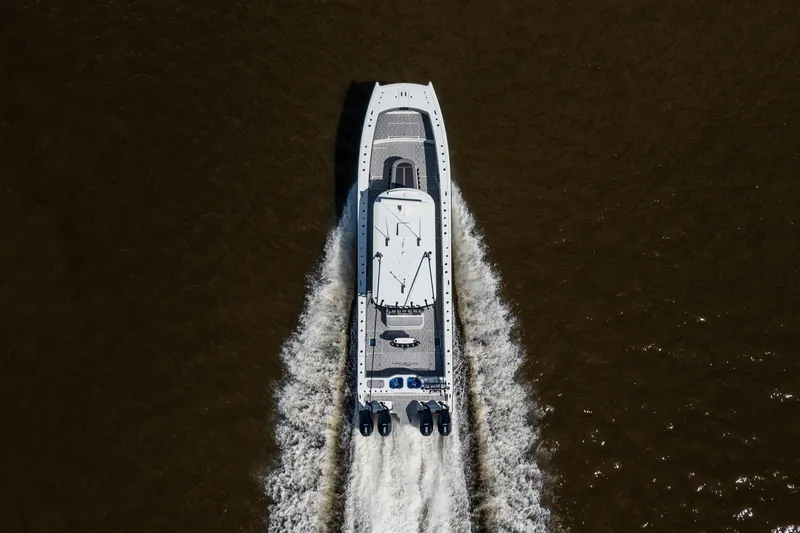Slide: The Image of Aerial view of 2023 Freeman 47 boat cruising on water, showcasing powerful engines. - 18