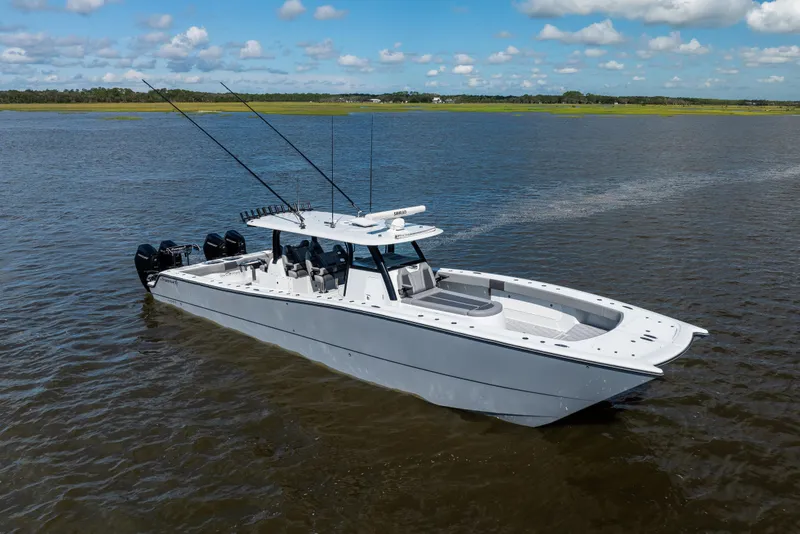 Slide: The Image of 2023 Freeman 47 boat on calm water under a blue sky with clouds. - 2