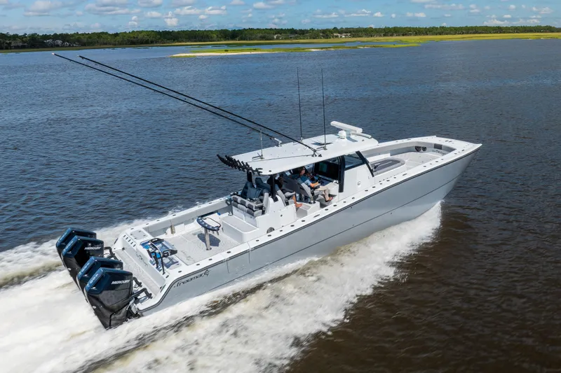 Slide: The Image of 2023 Freeman 47 boat cruising on a lake with powerful engines and sleek design. - 22