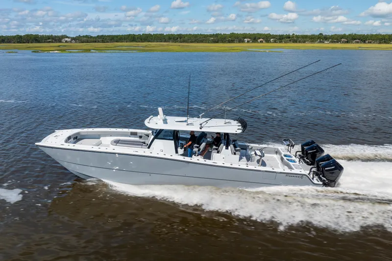 Slide: The Image of 2023 Freeman 47 boat cruising on a calm river under a blue sky. - 29