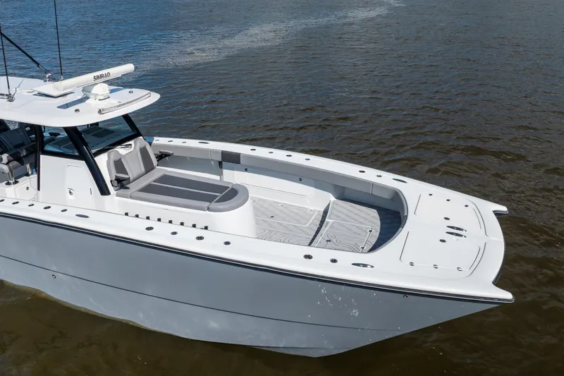 Slide: The Image of 2023 Freeman 47 boat on water, showcasing sleek design and spacious deck. - 3