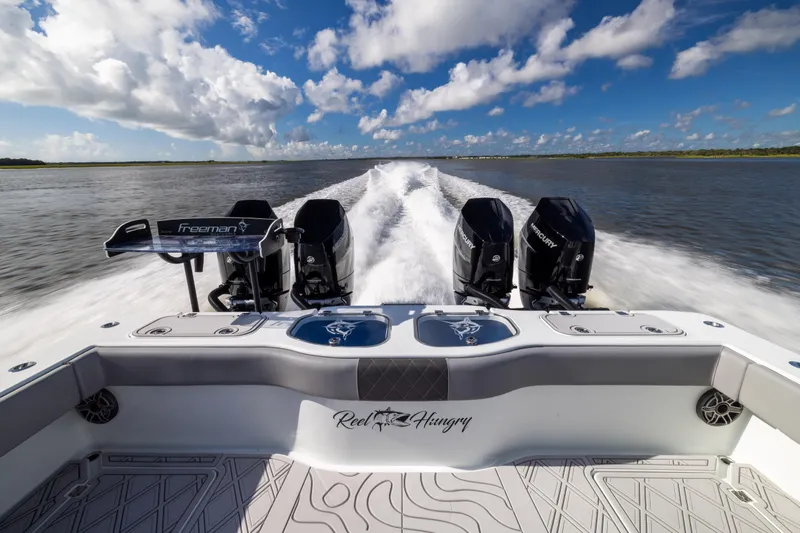 Slide: The Image of 2023 Freeman 47 boat speeding on water, showcasing powerful engines and sleek design. - 34