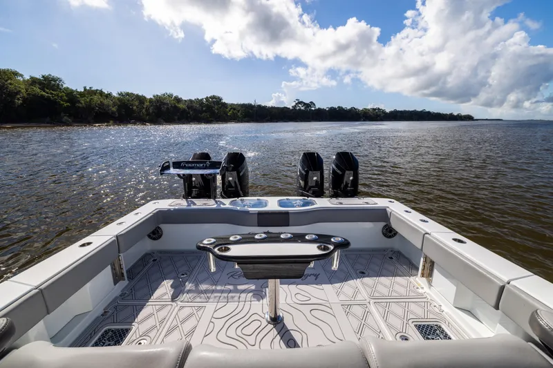 Slide: The Image of 2023 Freeman 47 boat with powerful engines on a serene waterway. - 36