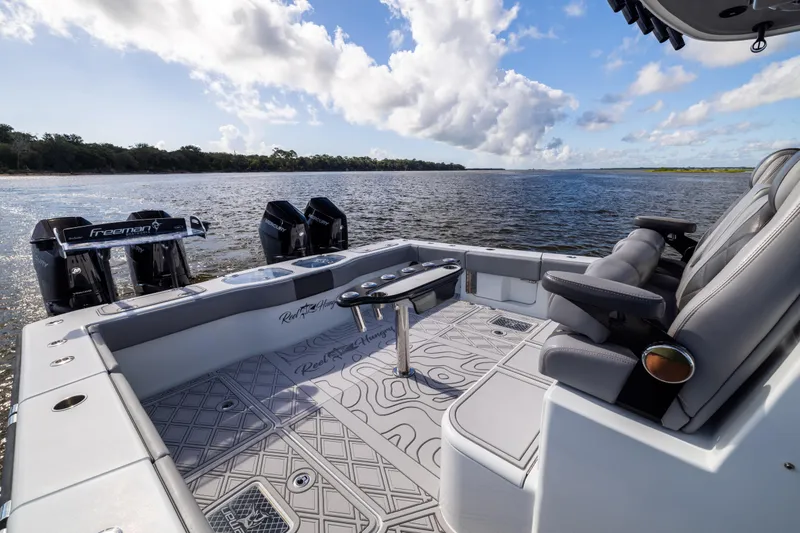 Slide: The Image of Luxury Freeman 47 boat interior, 2023 model, with plush seating and scenic water view. - 39