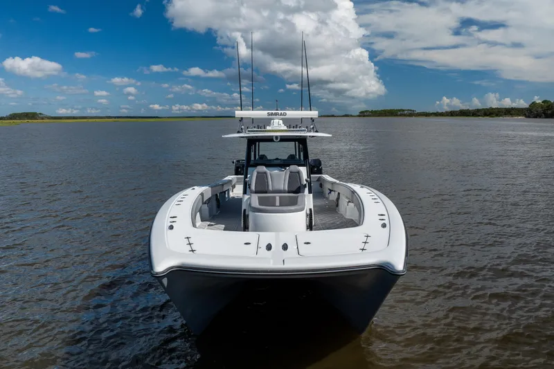 Slide: The Image of 2023 Freeman 47 boat on calm water under a blue sky with clouds. - 4
