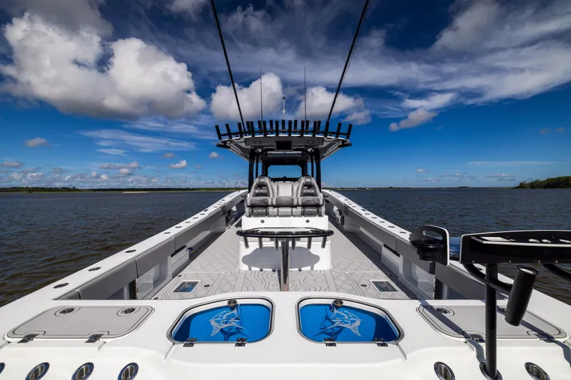 Slide: The Image of 2023 Freeman 47 boat on open water under blue sky with clouds. - 41