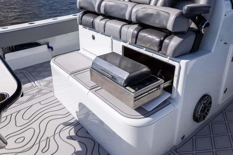 Slide: The Image of Luxury seating and grill setup on 2023 Freeman 47 boat, featuring sleek design and functionality. - 45