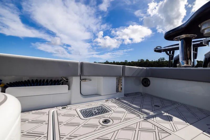 Slide: The Image of 2023 Freeman 47 boat deck with clear sky and lush landscape. - 48