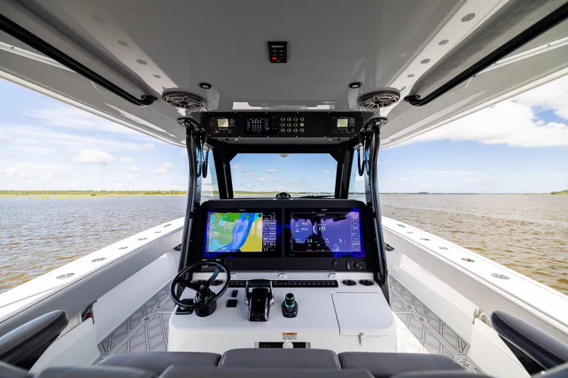Slide: The Image of Interior view of 2023 Freeman 47 boat cockpit with navigation screens and steering wheel. - 64