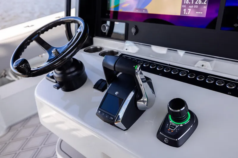 Slide: The Image of Control panel of 2023 Freeman 47 boat with steering wheel and navigation controls. - 71
