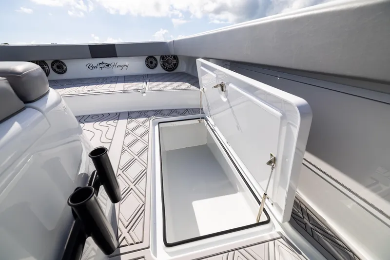 Slide: The Image of Open storage compartment on 2023 Freeman 47 boat deck with custom flooring. - 86