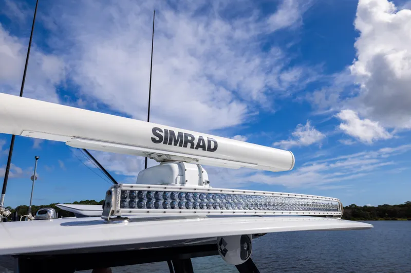 Slide: The Image of Radar and light bar on Freeman 47 boat, 2023 model, under a blue sky. - 87