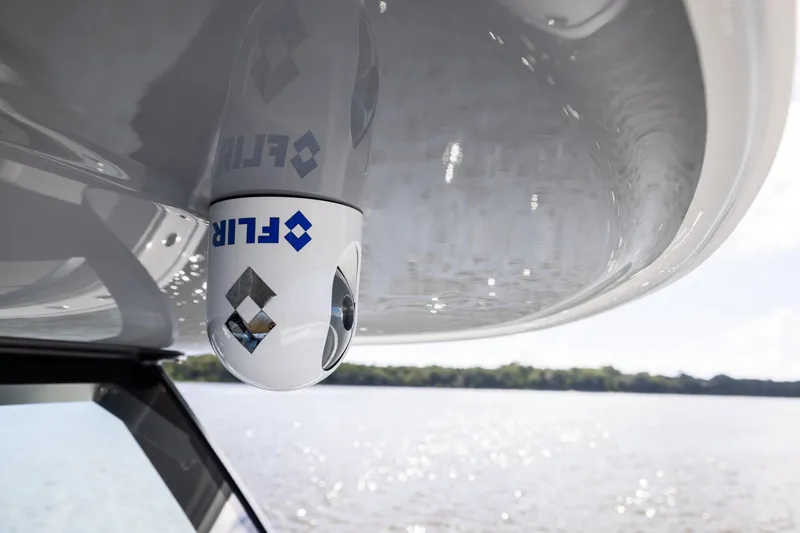 Slide: The Image of FLIR camera on Freeman 47 boat, 2023 model, with water and trees in the background. - 88