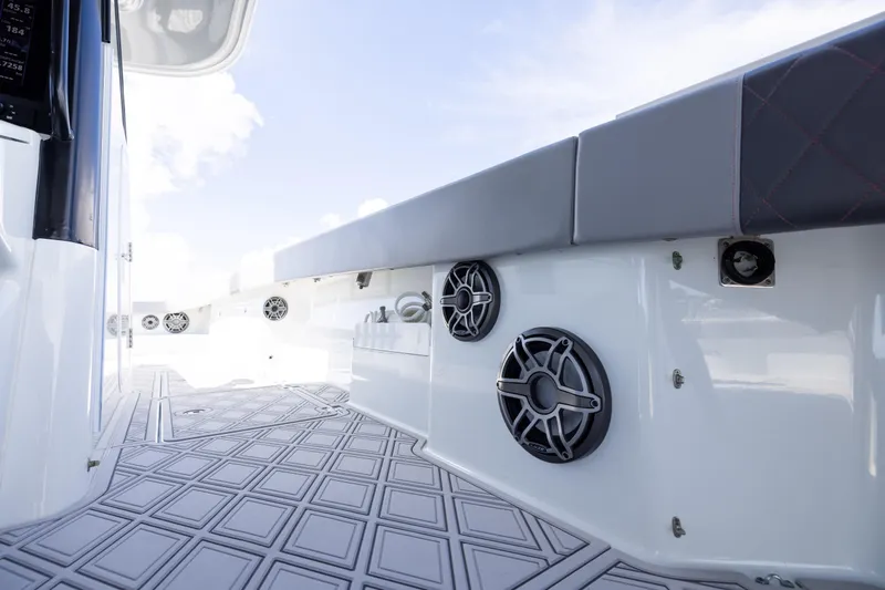 Slide: The Image of 2023 Freeman 47 boat interior with speakers and cushioned seating. - 95