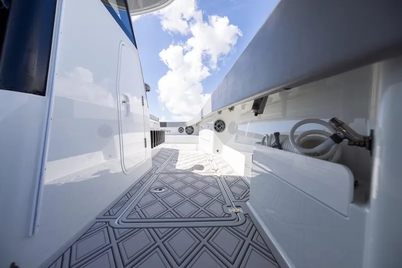 Slide: The Image of 2023 Freeman 47 boat deck with sleek design and modern features under a blue sky. - 96