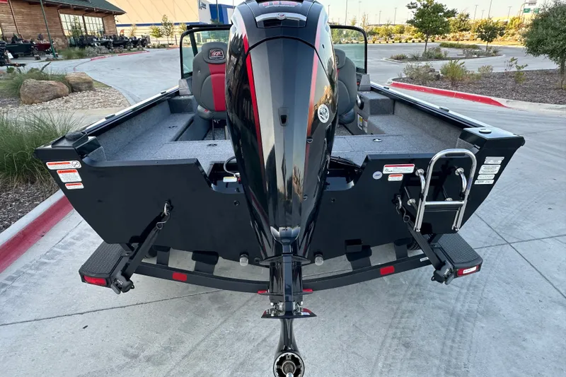 Slide: The Image of 2026 Ranger VS1682SC Angler boat with outboard motor, parked on a concrete driveway. - 5