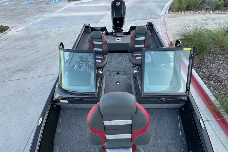 Slide: The Image of 2026 Ranger VS1682SC Angler boat interior with seating and windshield, parked on concrete. - 12