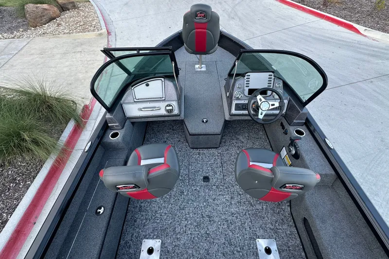Slide: The Image of 2026 Ranger VS1682SC Angler boat interior with dual seats, steering console, and carpeted flooring. - 11
