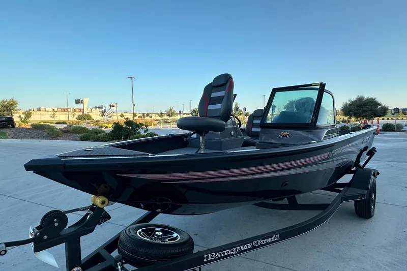 Slide: The Image of 2026 Ranger VS1682SC Angler boat on trailer, parked outdoors under clear sky. - 2