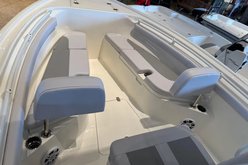 Slide: The Image of 2026 Mako 214 Center Console boat interior with cushioned seating and cup holders. - 65