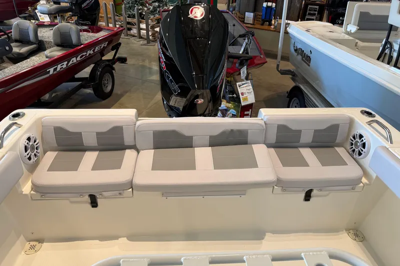 Slide: The Image of 2026 Mako 214 Center Console boat interior with cushioned seating and motor display. - 8