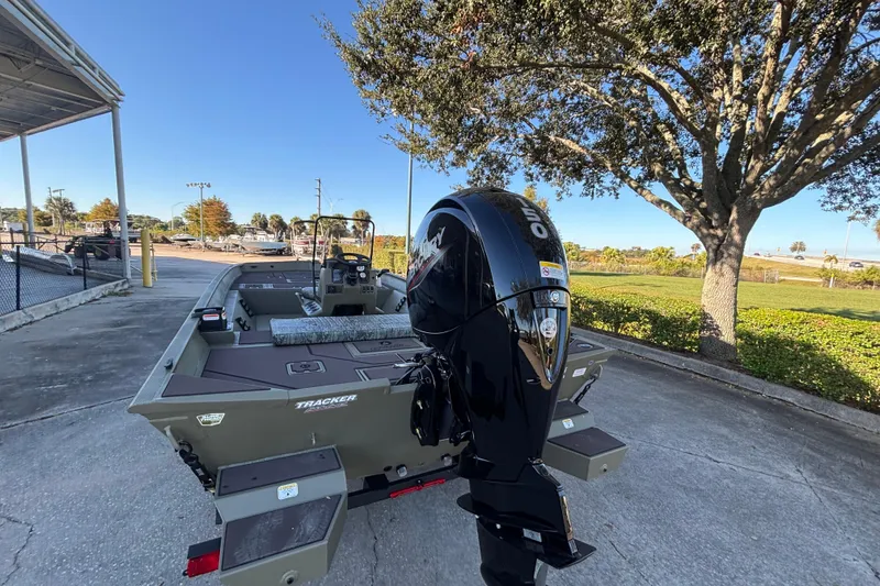 Slide: The Image of 2026 Tracker Grizzly 2072 CC boat with powerful outboard motor in a sunny outdoor setting. - 3