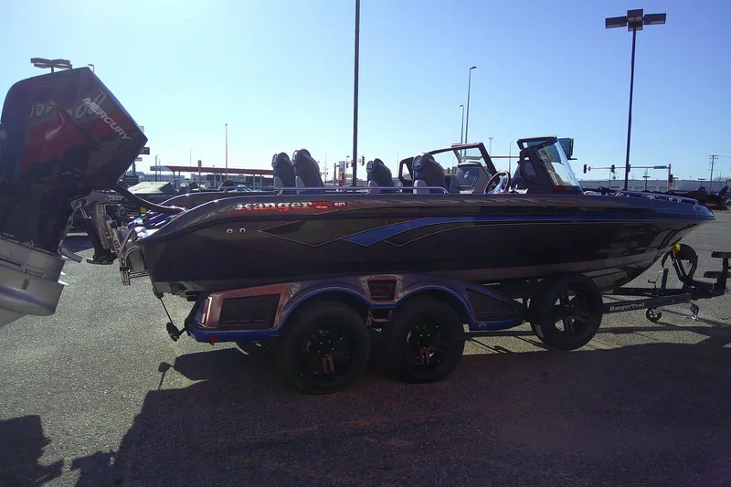 Slide: The Image of 2026 Ranger 621FS Pro boat on trailer, parked outdoors, featuring sleek design and powerful engine. - 3