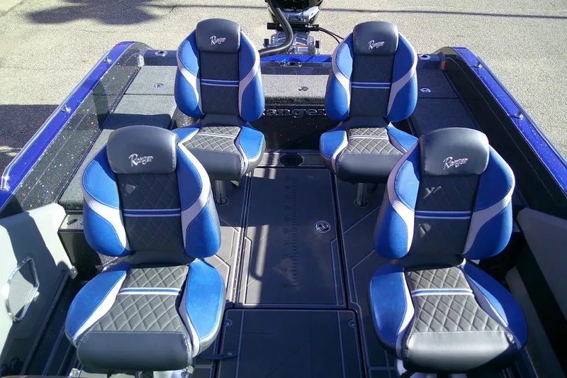 Slide: The Image of 2026 Ranger 621FS Pro boat interior with four blue and black cushioned seats. - 7