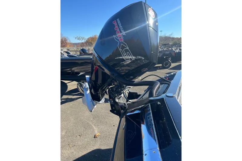 Slide: The Image of 2026 Ranger Z520R Cup-Equipped boat engine, outdoors in a sunny setting. - 4